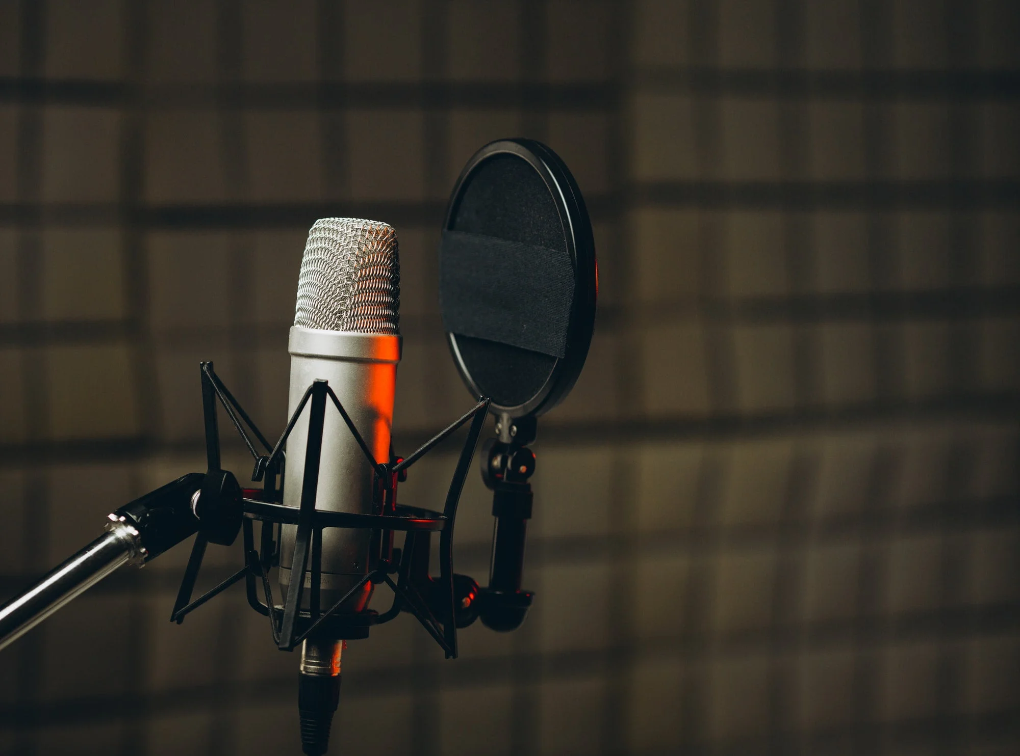 Pan shot of a professional microphone for dubbing and voice over in the sound recording studio.